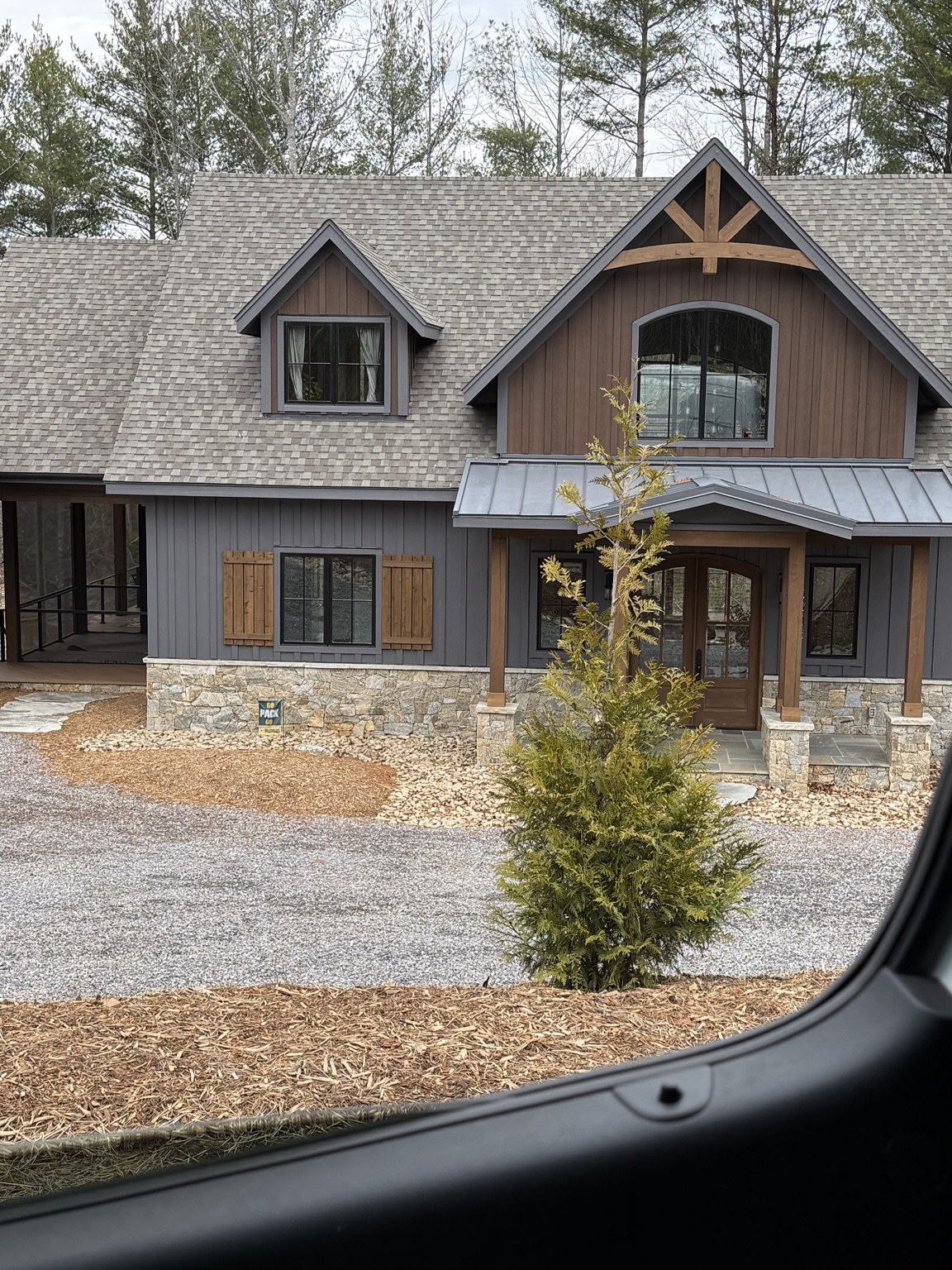 Front exterior of a home with timber and stone details